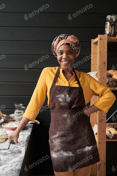 Preview: Baker in apron in the kitchen