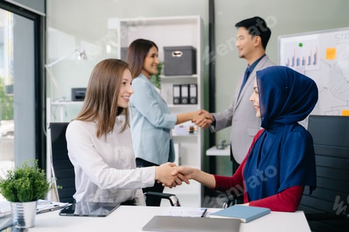 Preview: Two confident business man shaking hands during a meeting in the office