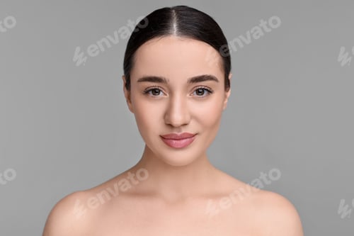 Preview: Portrait of beautiful young woman on grey background
