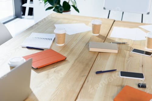 Preview: selective focus of digital devices and coffee to go on table in office