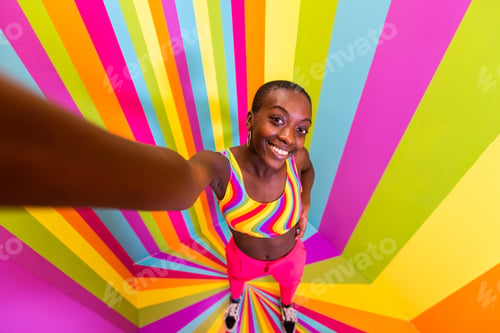 Preview: Beautiful young woman dancing and having fun inside a rainbow box room