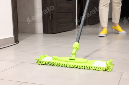 Preview: Woman cleaning floor with microfiber mop indoors, closeup