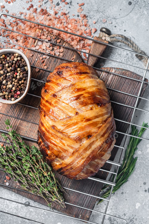 Preview: Baked meatloaf with bacon, meat loaf on a grill. Gray background. Top view