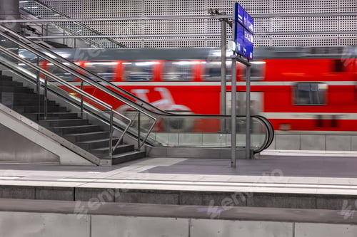Preview: Red train passing platform with motion blur. Speed and transport concept.