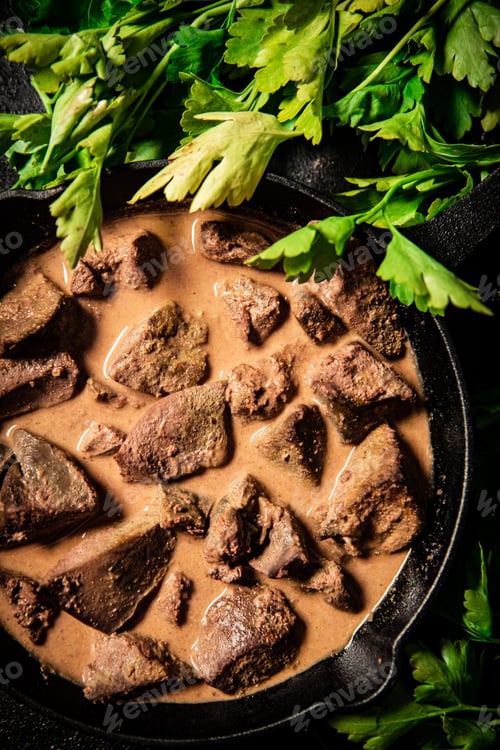 Preview: Fried liver in a frying pan with parsley.