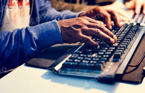 Preview: Closeup of hands working on computer keyboard