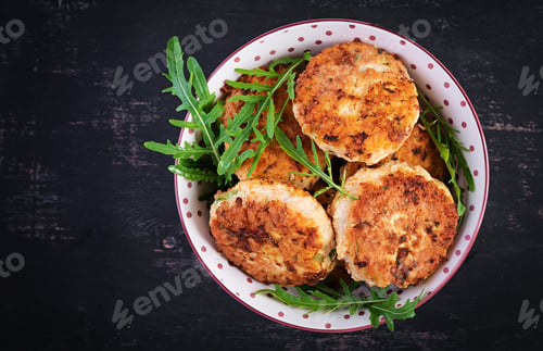 Preview: Healthy dinner. Chicken cutlets in a bowl on a dark background. Top view, flat lay