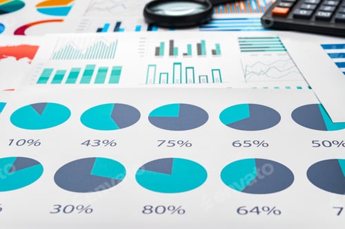 Preview: Business graphs and magnifying glass on table