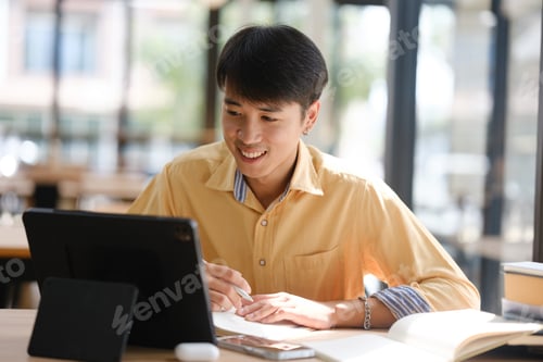Preview: Student studying online and preparing for exams with digital devices and books