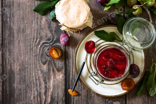 Preview: Homemade preservation. Delicious plum jam on a rustic wooden table.