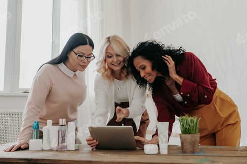 Preview: Three mature women buying beauty products online while spending time together