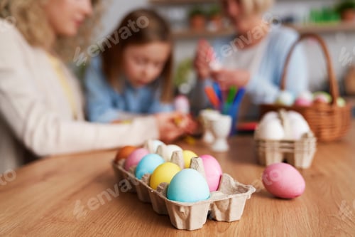 Preview: Close up of carton of colored Easter eggs in the table