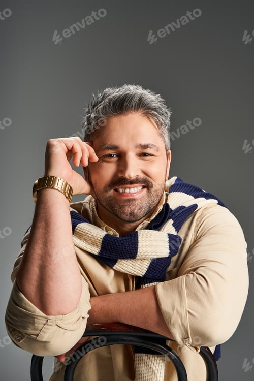 Preview: Stylish man showcasing trendy fashion in a modern studio setting
