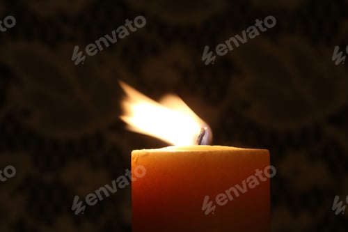 Preview: Burning Candle With Blowing Flame - Close Up Photograph Of A Burning Candle With The Flame Blowing