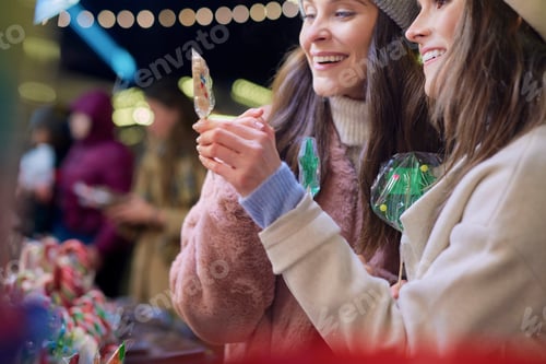 Preview: Friends buying candies Christmas market at night
