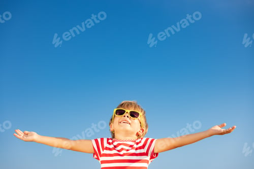 Preview: Happy child having fun outdoor against blue sky