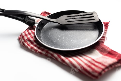 Preview: Frying Pan and Spatula on Striped Napkin