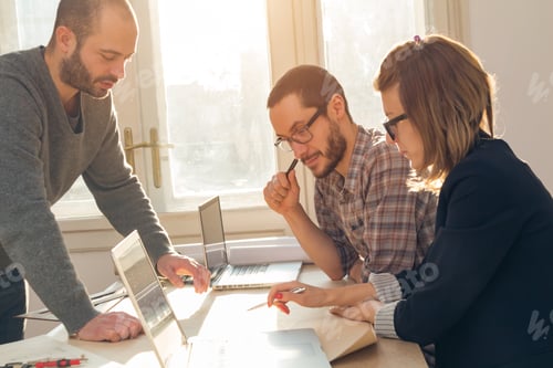 Preview: Three Colleagues Working From Home On A Project.