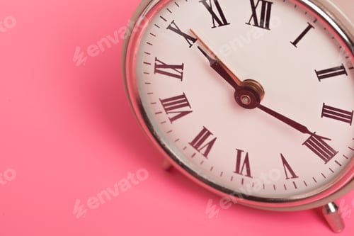 Preview: Clock showing time with Roman numerals on pink background in simple design