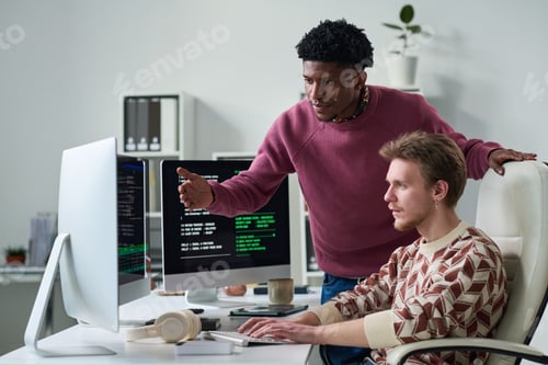 Preview: Young Black Man Explaining Programming Code to Young Man