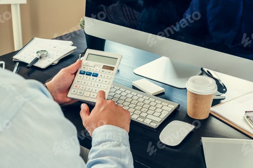 Preview: Young man businessman sitting at his working table in office