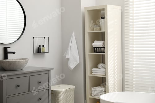 Preview: Stylish bathroom interior with grey chest of drawers and shelving unit