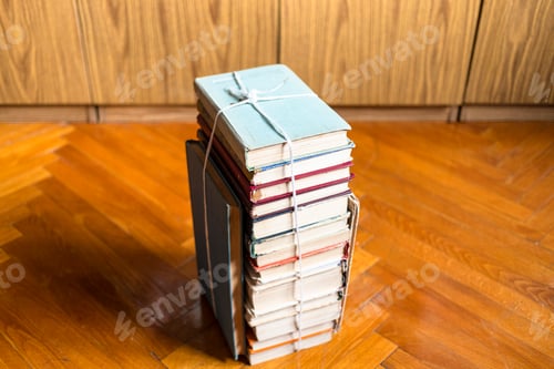 Preview: above view of stack of old books tied with twine
