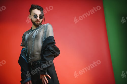 Preview: Young, handsome gay man on a colored background in the studio. LGBT concept.