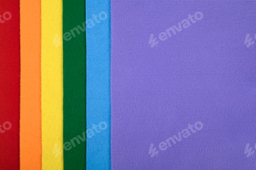 Preview: Felt samples in rainbow colors in a vertical arrangement. There is space for text.