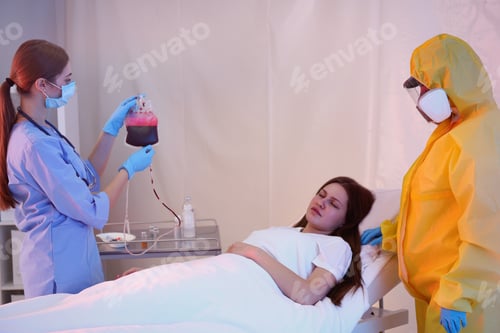 Preview: Professional paramedics examining patient with virus in quarantine ward