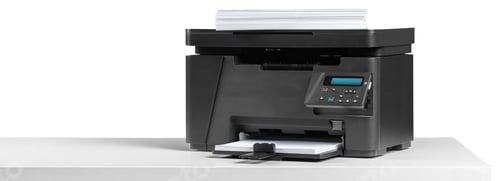 Preview: Office printer placed on a table with paper loaded in the tray for printing documents