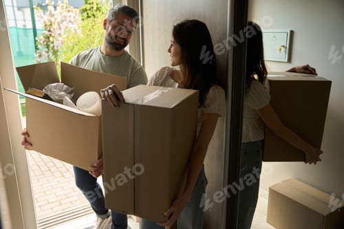Preview: Couple in love bringing boxes into home