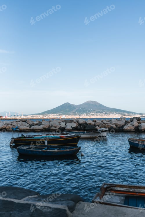 Preview: boats moored in the sea with Vesuvius in the background
