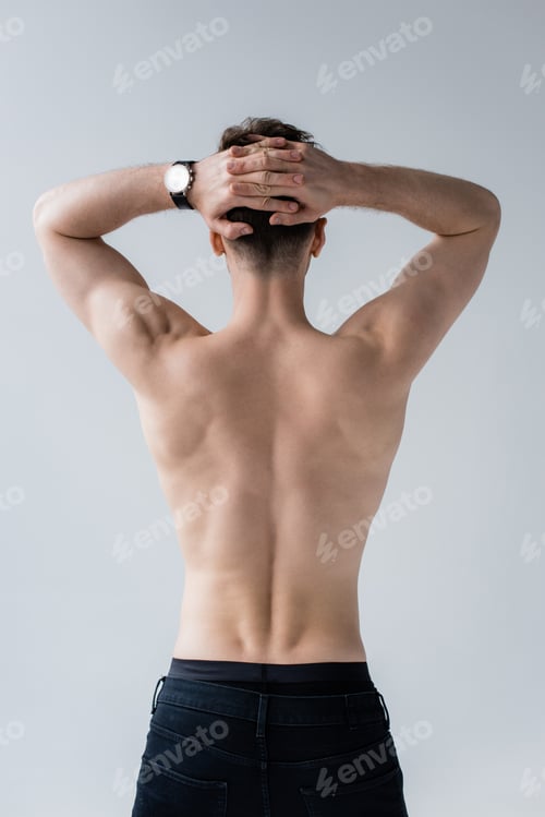 Preview: back view of shirtless muscular man in jeans isolated on grey