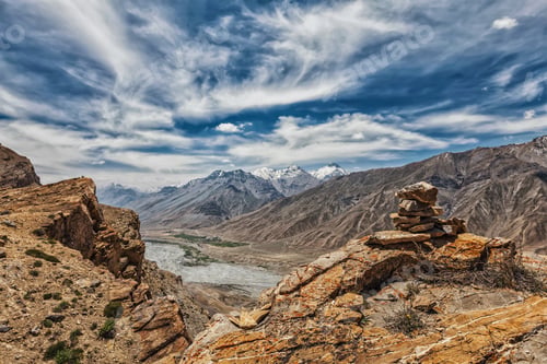 Preview: View of valley in Himalayas with stone cairn on cliff