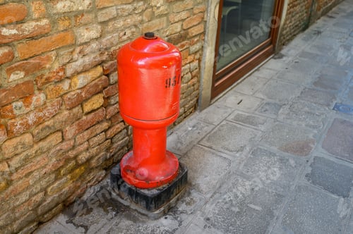Preview: Classic red hydrant in the street of Venice. Italy.