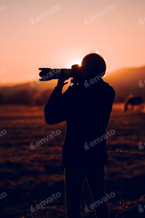 Preview: Man shooting on camera beautiful landscape between hills