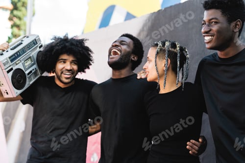 Preview: Happy group of multiracial people having fun listening music with vintage boombox outdoor