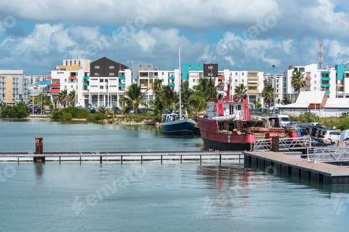 Preview: Beautiful shot of boats docked in harbor and buildings with cloudy sky in the background