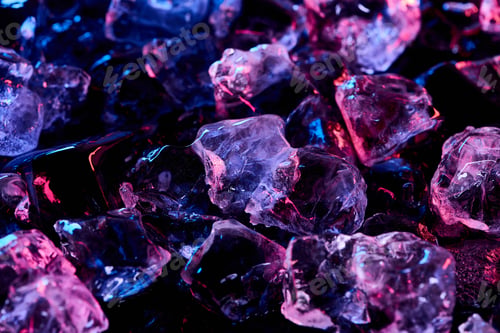 Preview: transparent ice cubes with purple illumination isolated on black