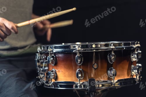 Preview: A man plays a drum. Drumsticks are hit on the drum.
