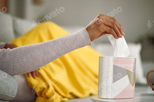 Preview: Close-up of African American woman taking tissue from a box.