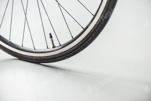 Preview: bicycle wheel with rim, tire and spokes with valve on white
