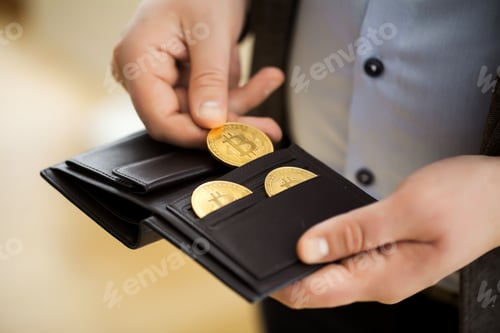 Preview: Golden bitcoin coins in man hands.