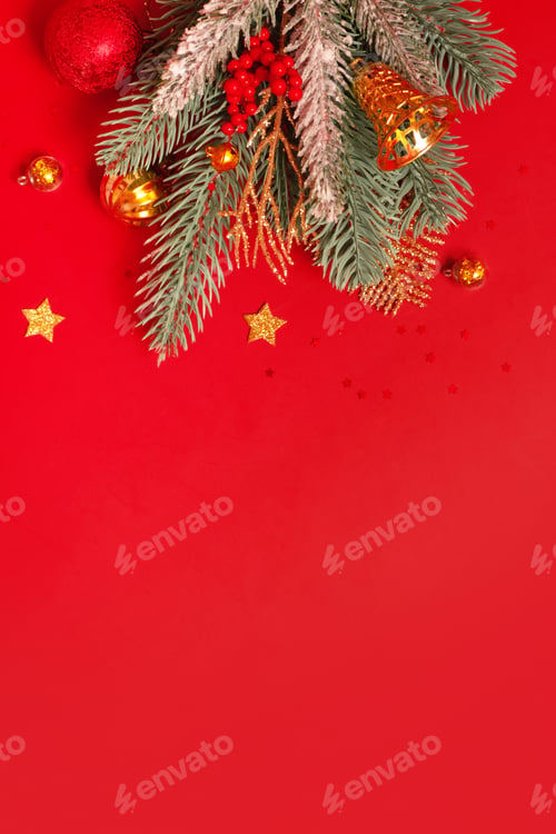 Preview: Christmas decoration and pine tree on red background with copy space. New Year greeting card