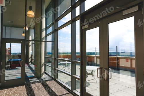 Preview: Glass doors and walls on the top floor of a chic college city apartment building downtown Ann Arbor