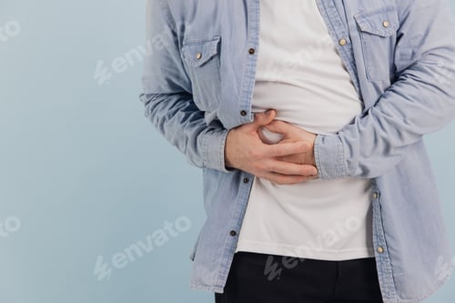 Preview: Senior man suffering from abdominal pain on blue background