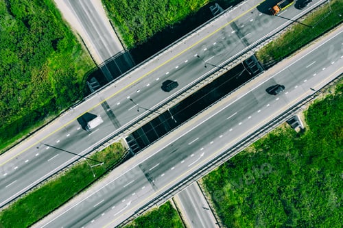 Preview: Aerial drone view of highway asphalt road with cars and cargo trucks.