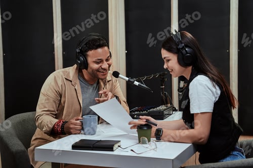 Preview: Portait of two radio hosts, man and woman talking with each other, reading a script