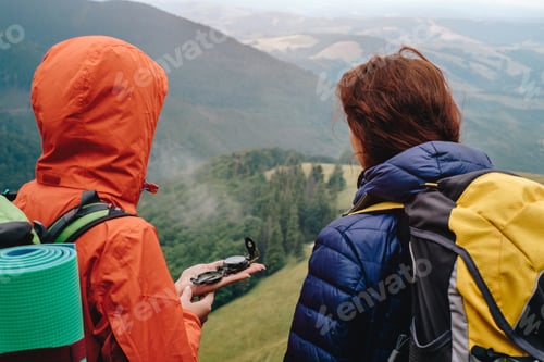 Preview: People using compass in mountain